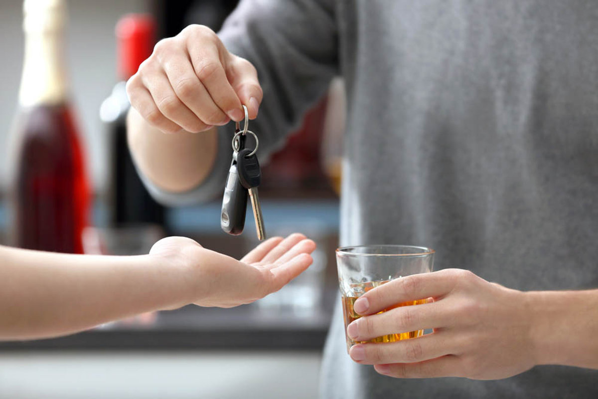 person drinking handing over his keys