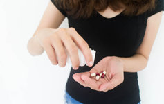 young woman taking prescription pills