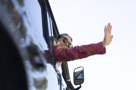 Waving from a car