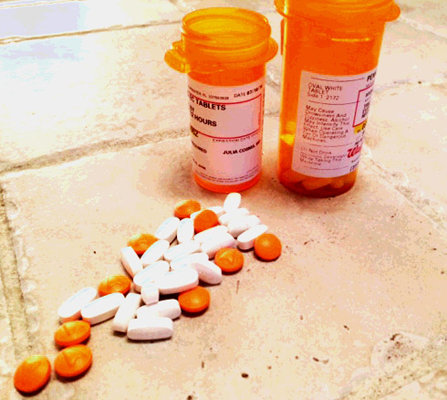 Two prescription bottles and pills