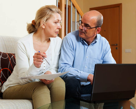 mature couple talking in front of computer