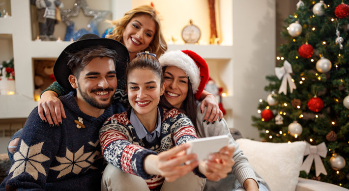 Friends create a memorable Christmas selfie.
