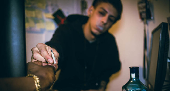 young men smoking marijuana