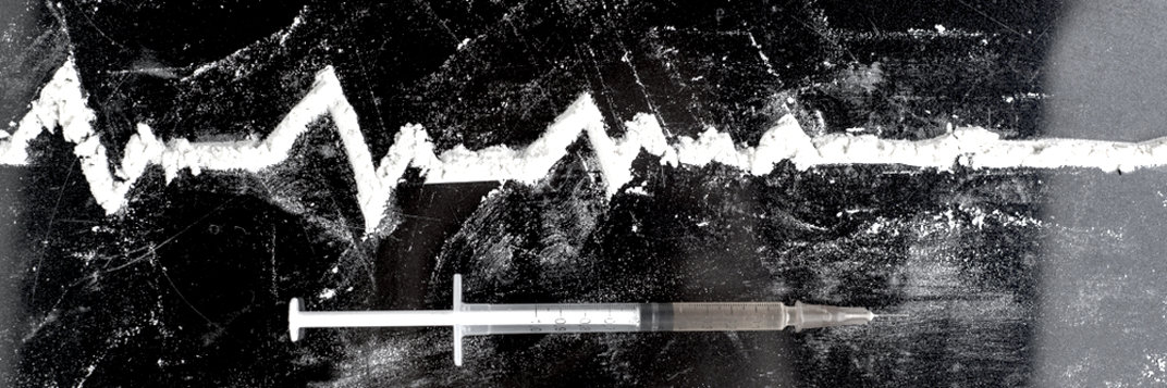 Powder on the surface in the shape of heart rate and syringe.