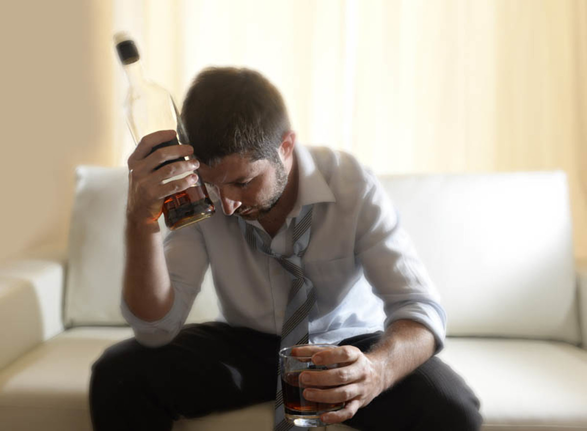 man drinking alcohol with bottle