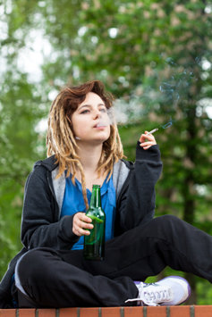 A young girl smoking marijuana.