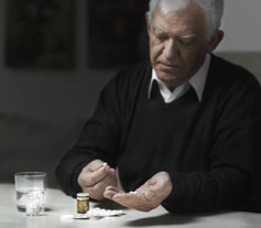 senior man taking prescription medication