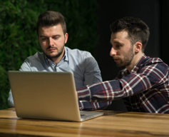 two young men reviewing a website
