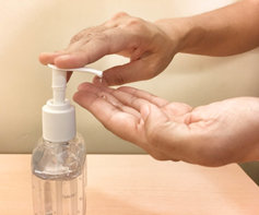person dispensing hand sanitizer