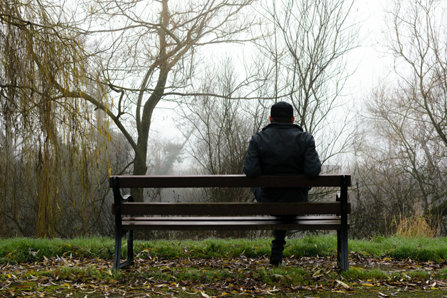 Man sitting in a misty park