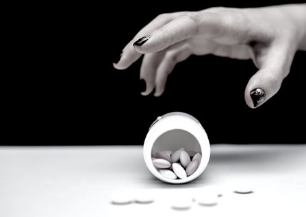 Teenagers hand reaching for pills
