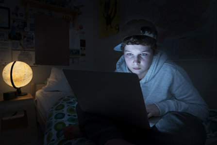 Teenager web-surfing at night