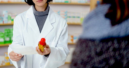 Pharmacist dispenses pills as ordered by a doctor.