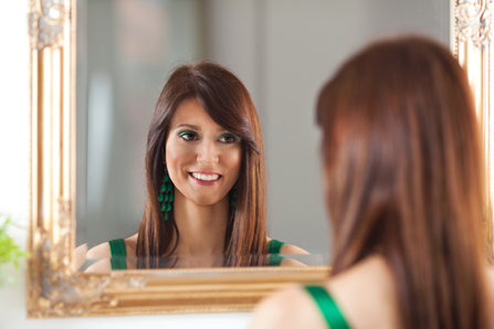 Woman looking into a mirror.