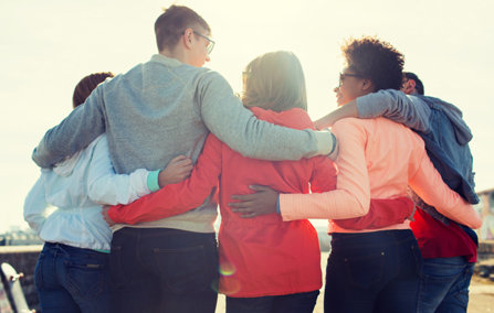 A group of friends hug each other.