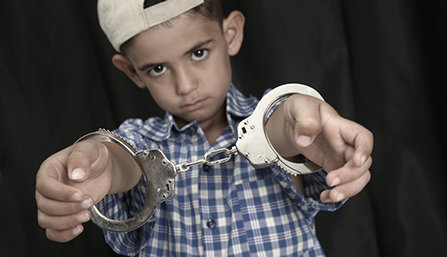 Kid in handcufs