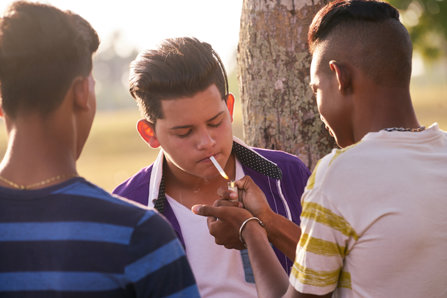 Hispanic teenagers smoking pot.