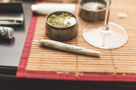 Joint and alcohol laying on the table.