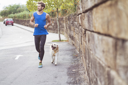Man is jogging with a dog