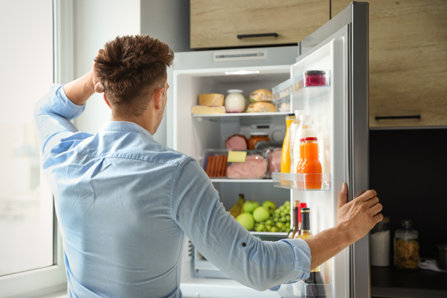 Man takes a look at his fridge