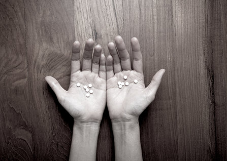Both hands with pills.