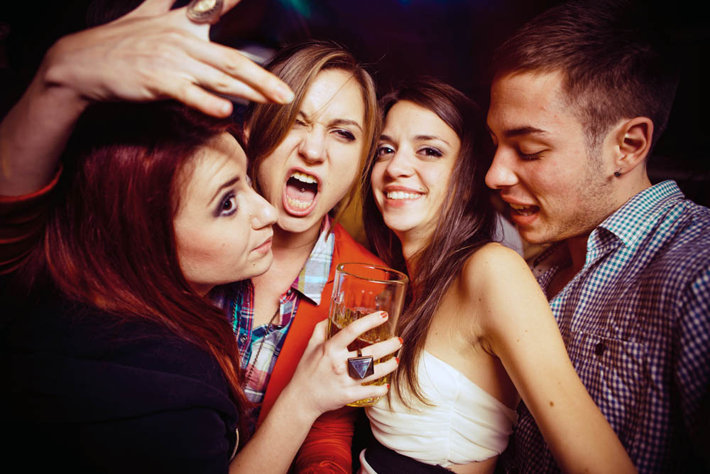 young adults drinking alcohol at a club