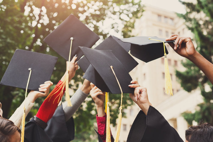 College graduates rising hats