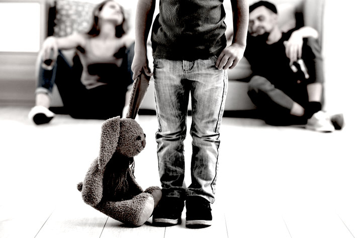 Parents addicts, child standing with a toy.