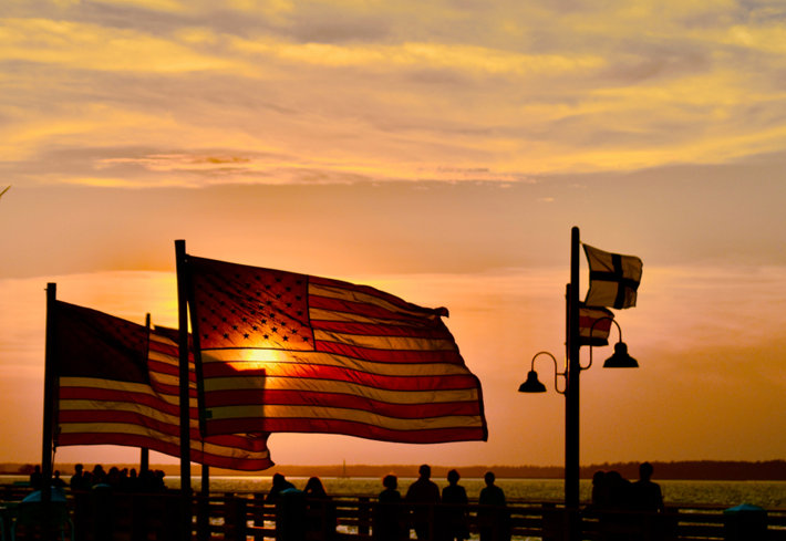 Sun shinning through american flag