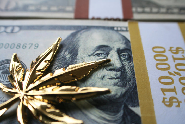 Golden marijuana symbol and U.S. dollars.