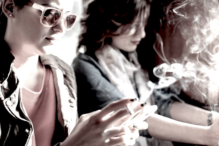 Two teenager girls smoking marijuana.