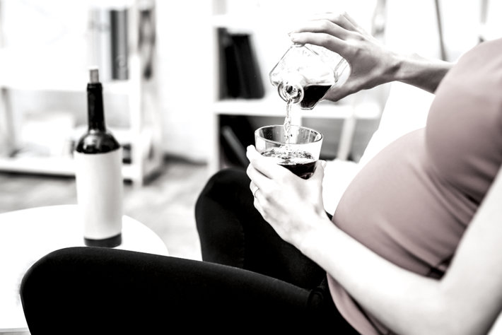 Pregnant woman drinking alcohol.