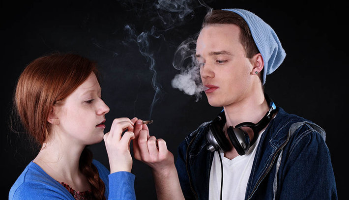 two teens smoking marijuana
