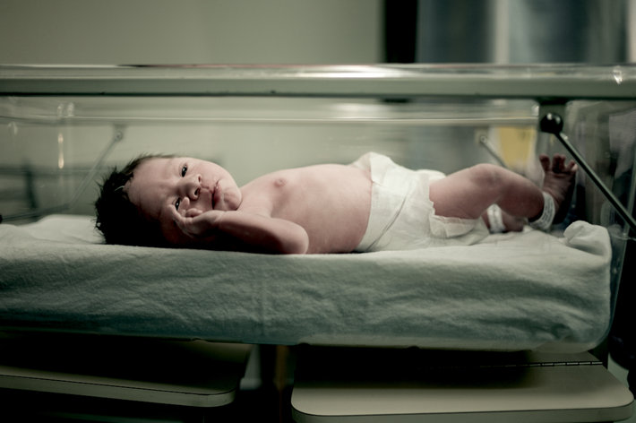 Newborn baby inside an incubator
