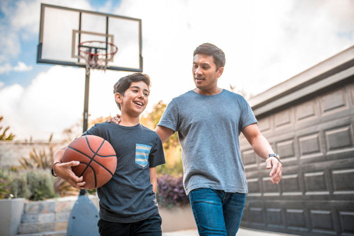 Dad with son playing basketball